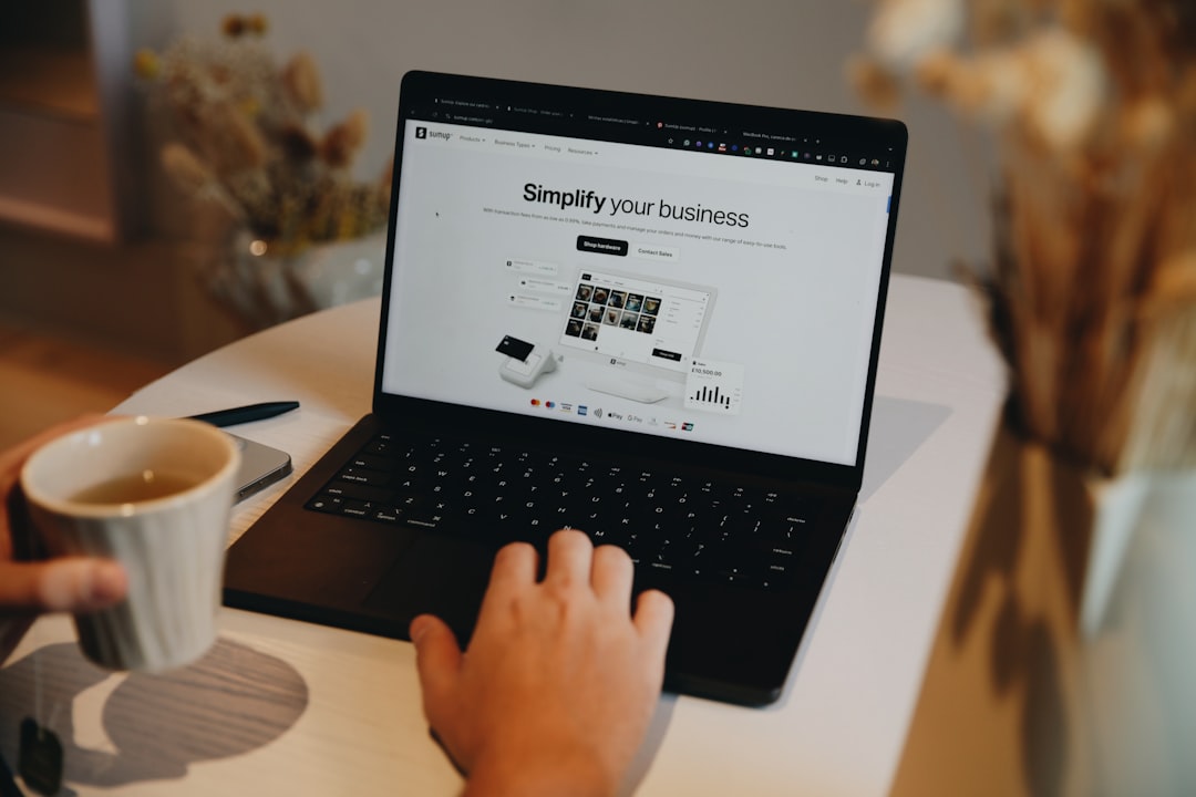 Viewing the SumUp website on a laptop, highlighting tools for small businesses, including payment systems and financial management solutions.